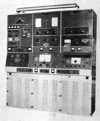 Huge shipboard console - 3 rack panels wide with several receiver and transmitter units.